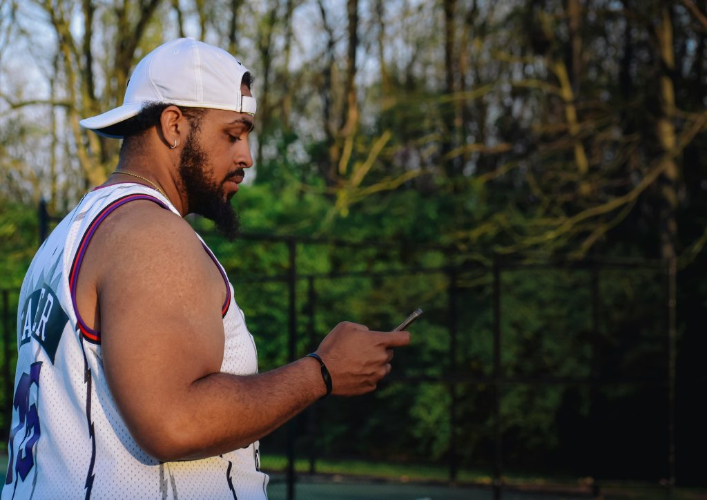 Image of male looking at his phone