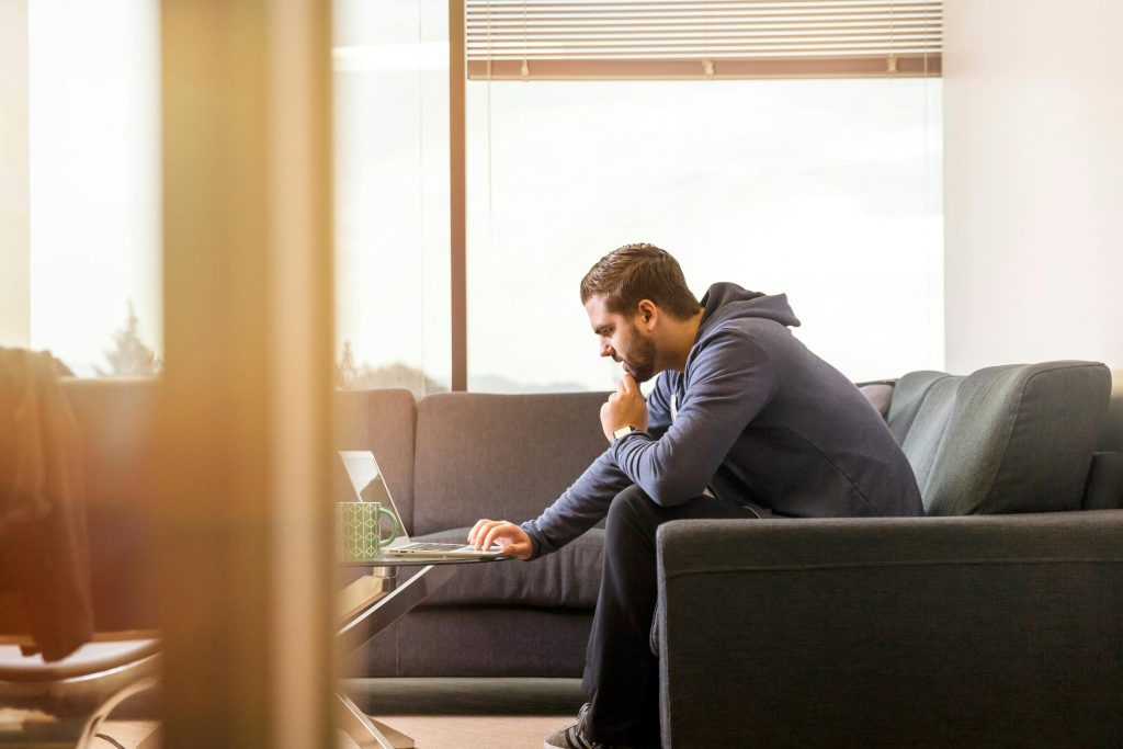 Image of male looking at his laptop